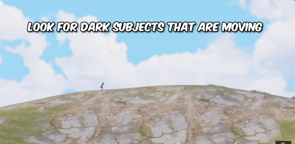 5 Amazing Skills to Dominate PUBG Like a Pro Tactical gameplay screenshot from PUBG Mobile illustrating a player spotting technique to find moving targets on rocky hills.